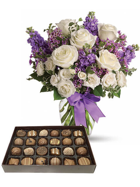 Rose bianche, fiori viola e scatolo di cioccolatini